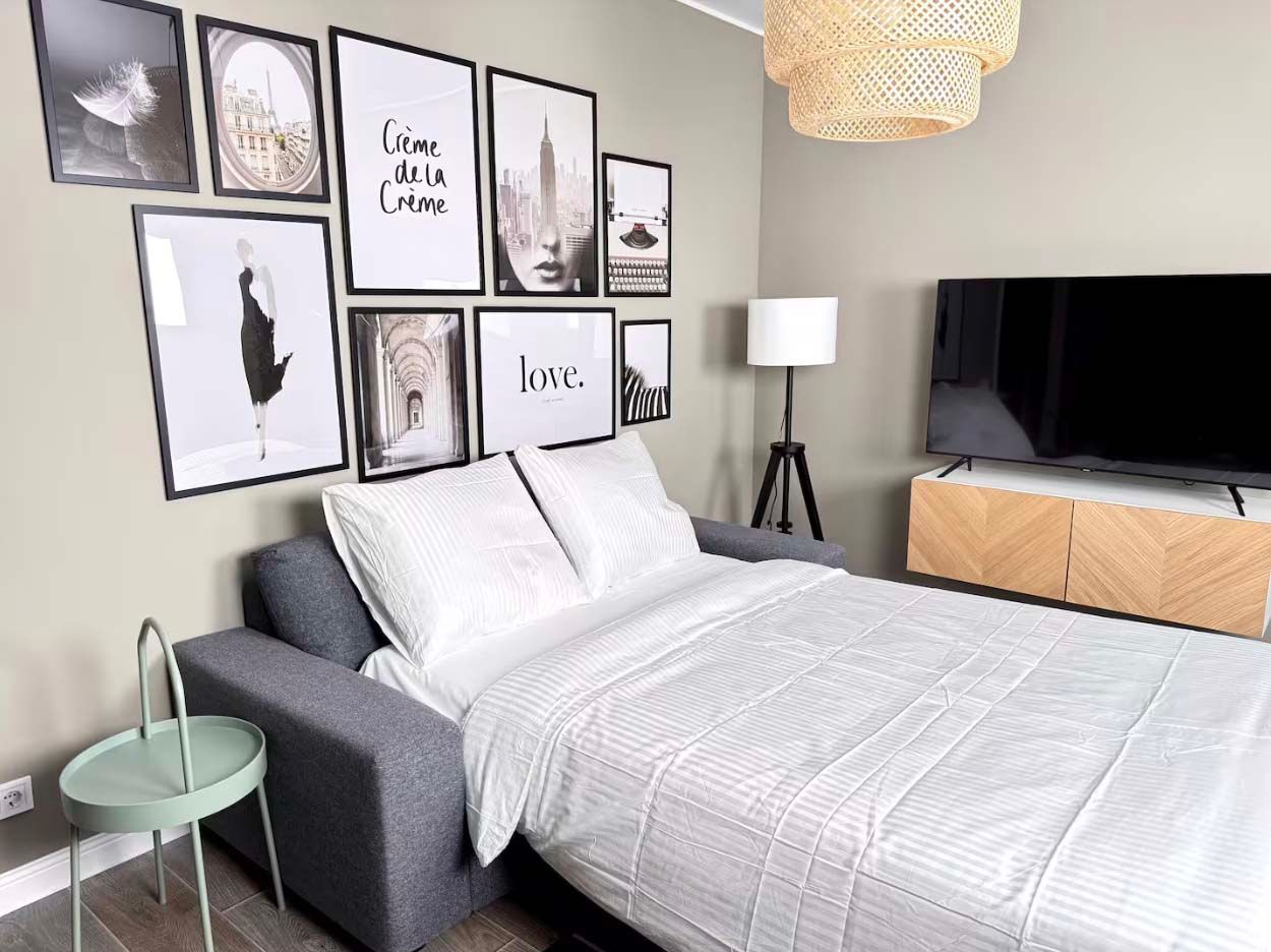 A sofa bed in the living area of the Stylish Design Apartment Airbnb.