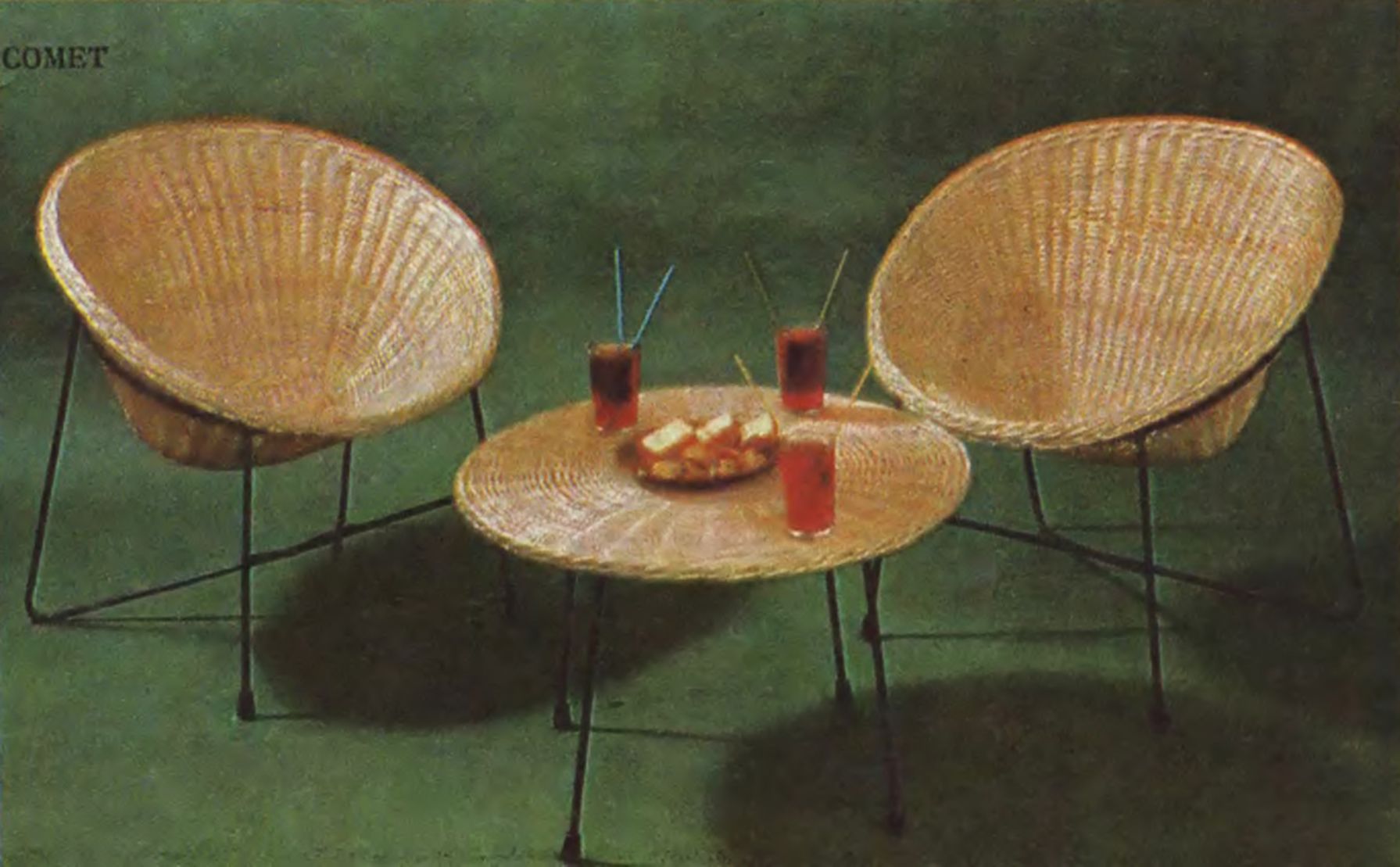 Rattan chairs and a table with drinks and food on the table.