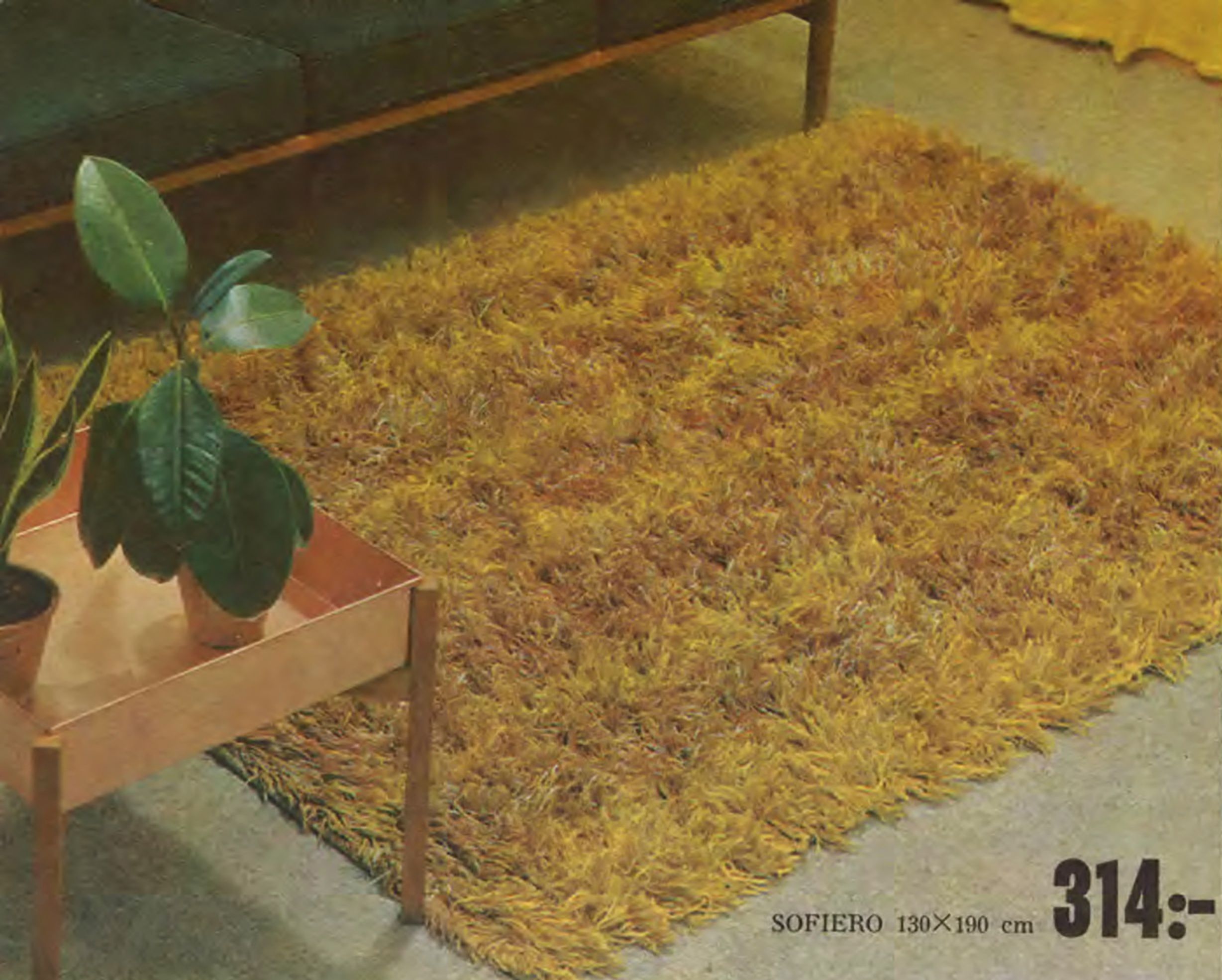 A fluffy yellow shag pile rug next to a planter table in the 1965 catalogue.
