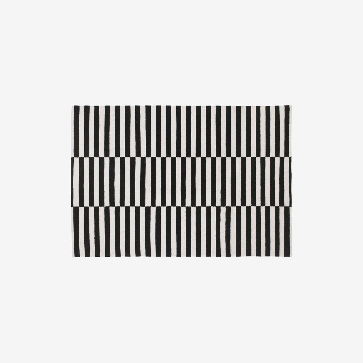 A black-and-white patterned STOCKHOLM rug on a light grey background.