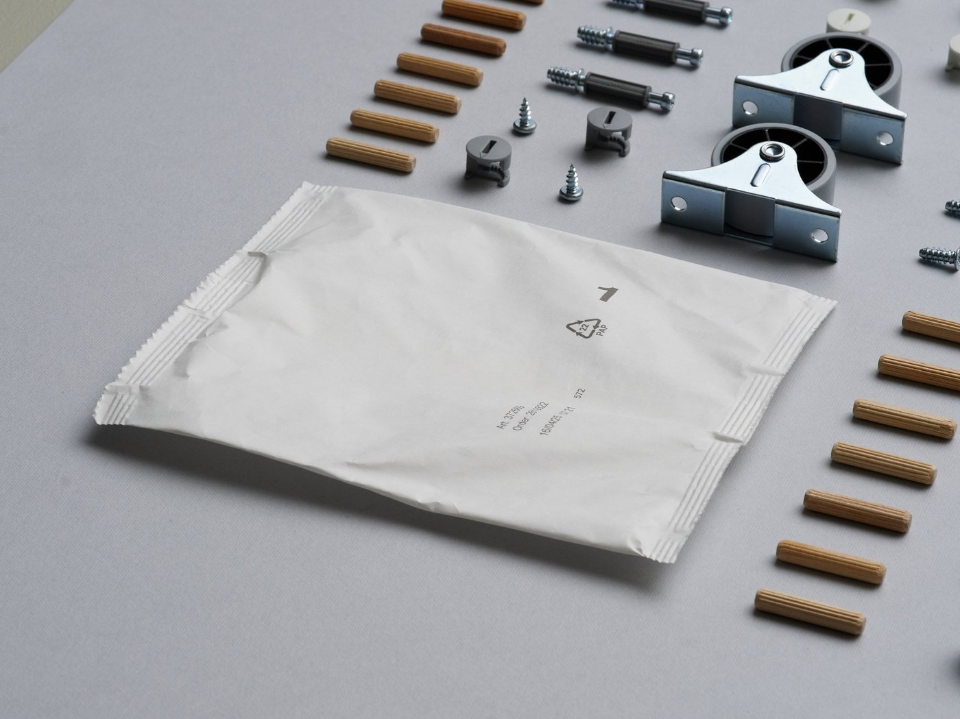 A paper-based bag next to neatly lined up fittings.