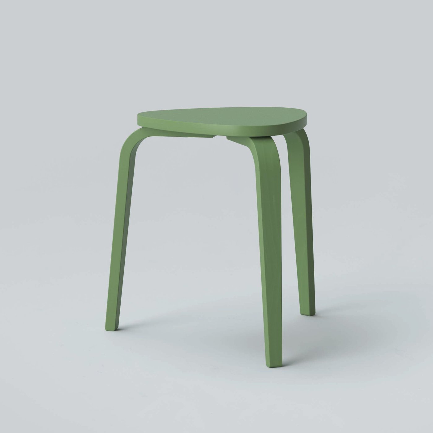 A green three-legged KYRRE stool against a grey background.