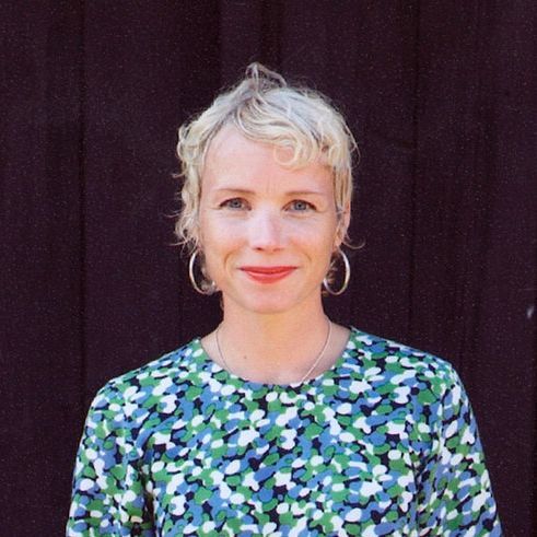 A colour portrait of designer Maria Vinka smiling at the camera.