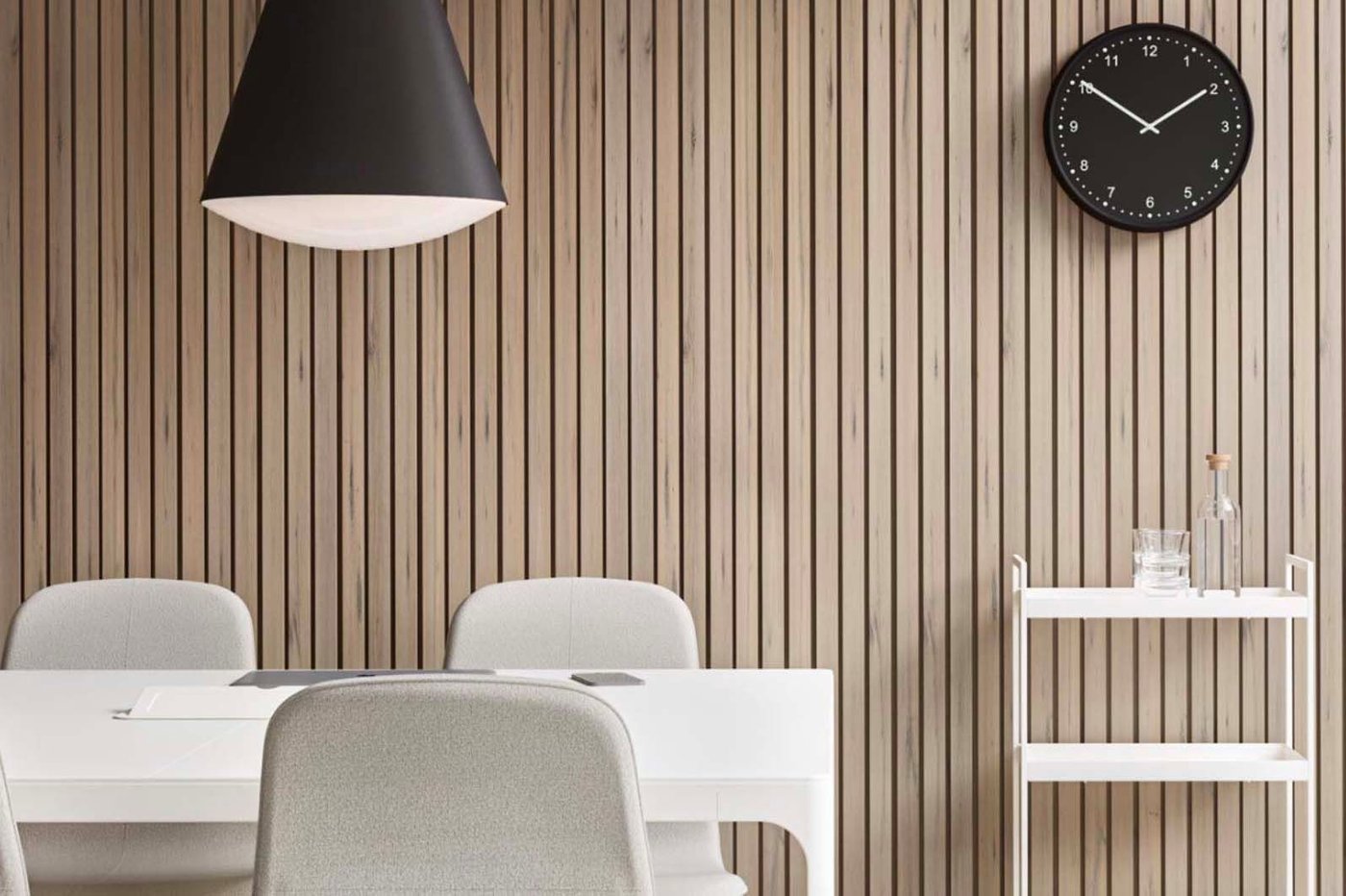 An office space with pre-loved table and chairs, trolley and a wall clock.