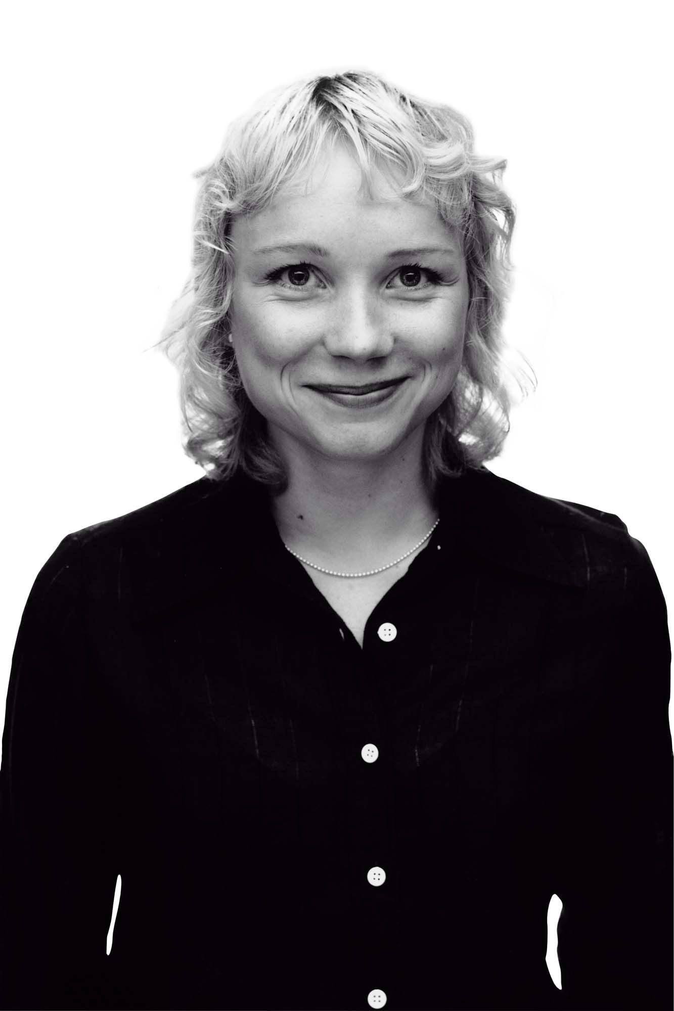 A black-and-white headshot of designer Maria Vinka smiling at the camera.
