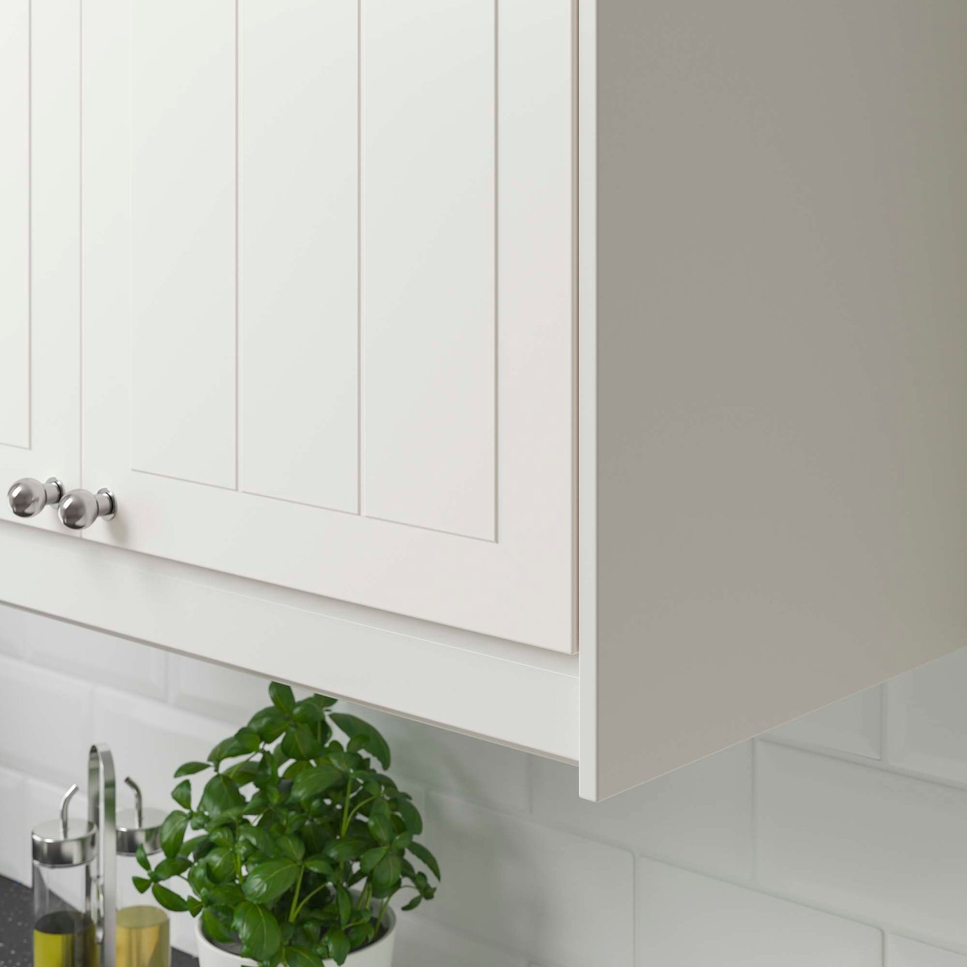 Groove detailing on a white STENSUND kitchen front.