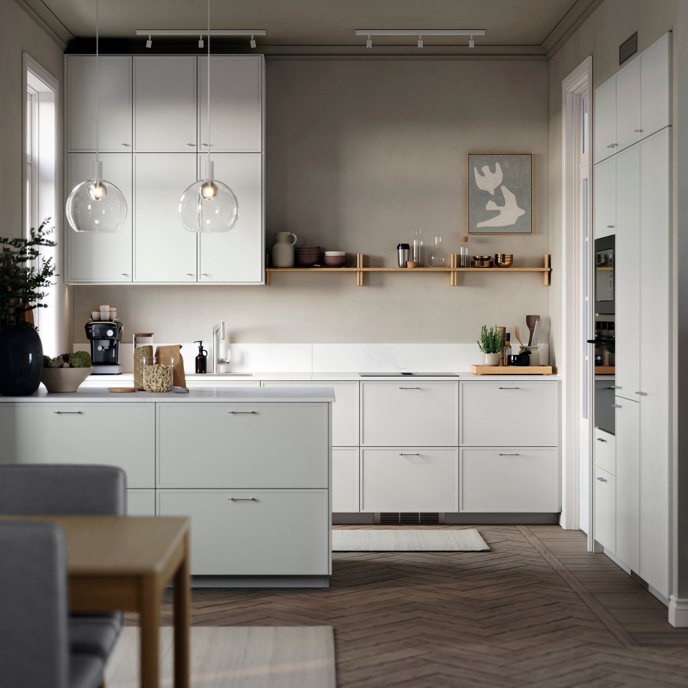 A pale grey, minimal kitchen with white kitchen cabinets with a pared-back design.