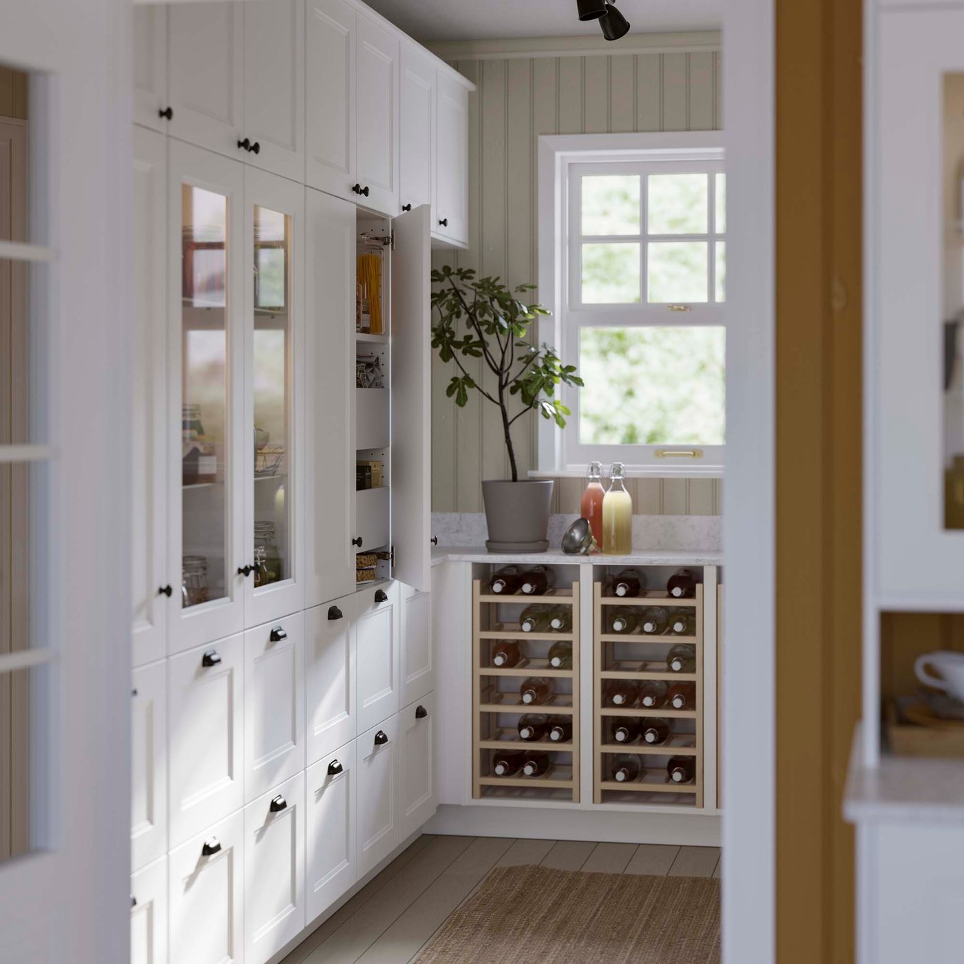 Two vertical bottle racks installed in the lower section of white kitchen cabinets.