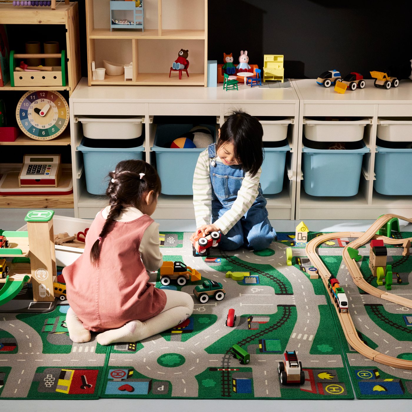 Two children playing with transport-themed toys from the LILLABO series. 