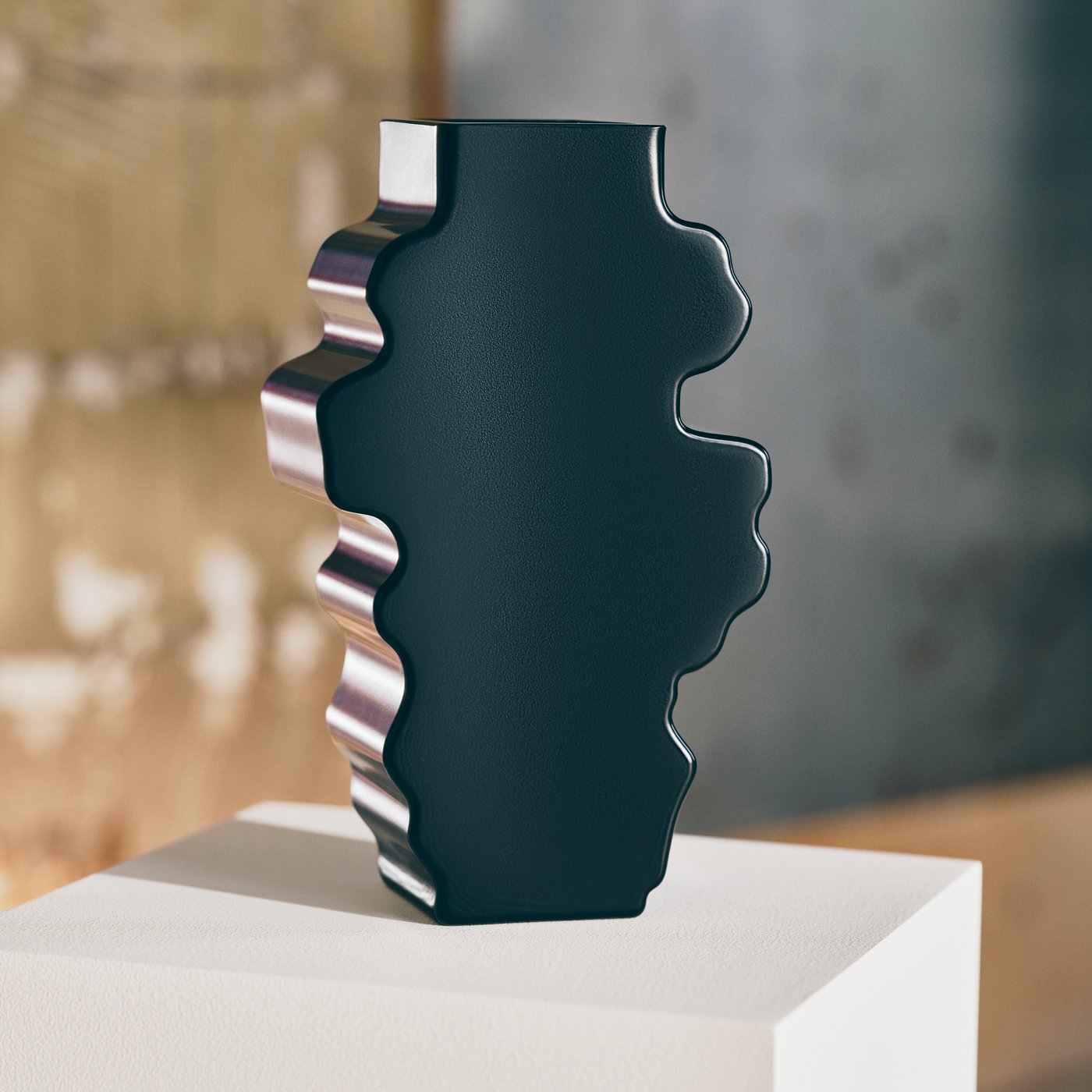 Black abstract sculpture with a wavy, irregular silhouette displayed on a white plinth in an industrial gallery.
