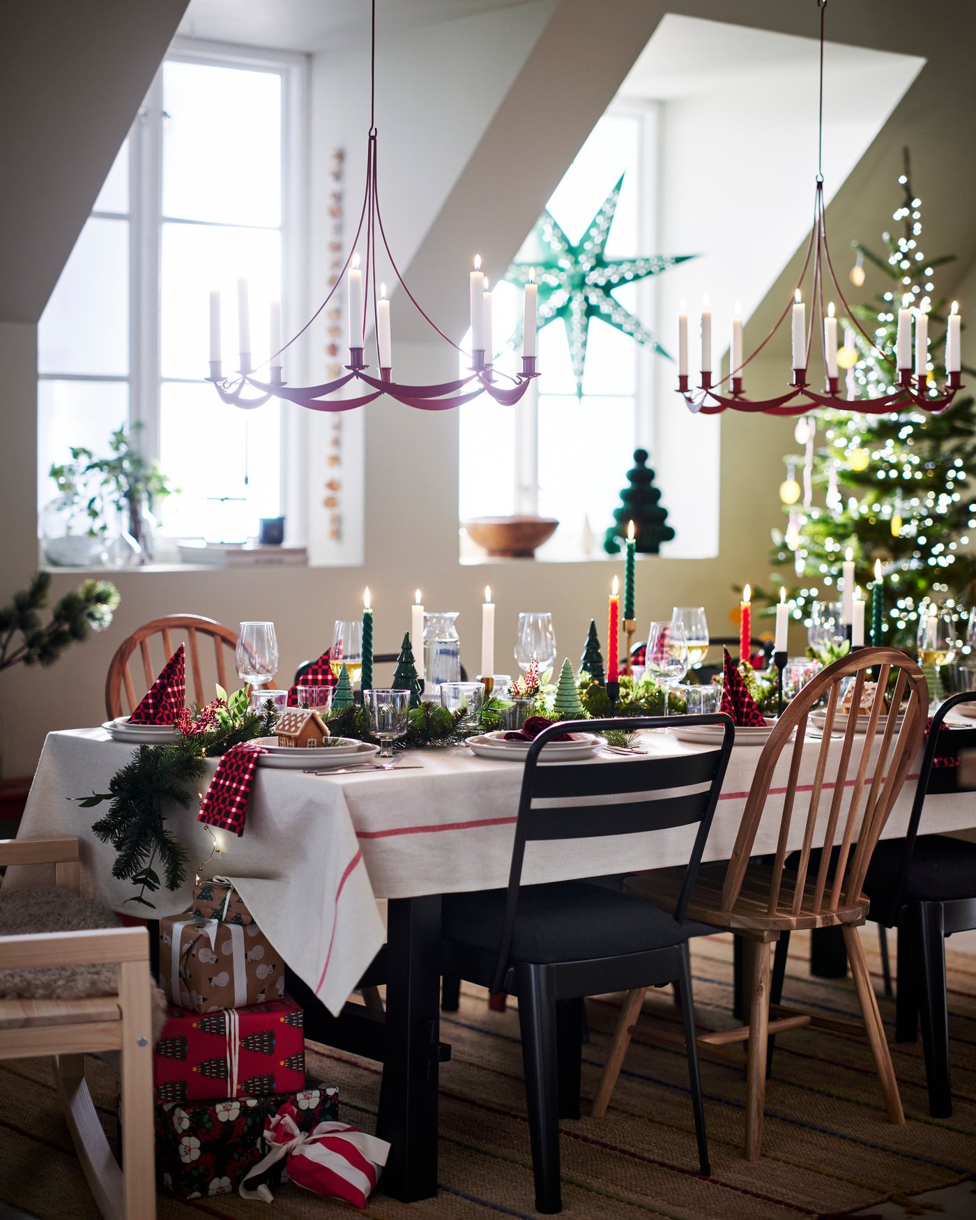 A dining room prepared for a celebration with decorations, flowers and a set table.