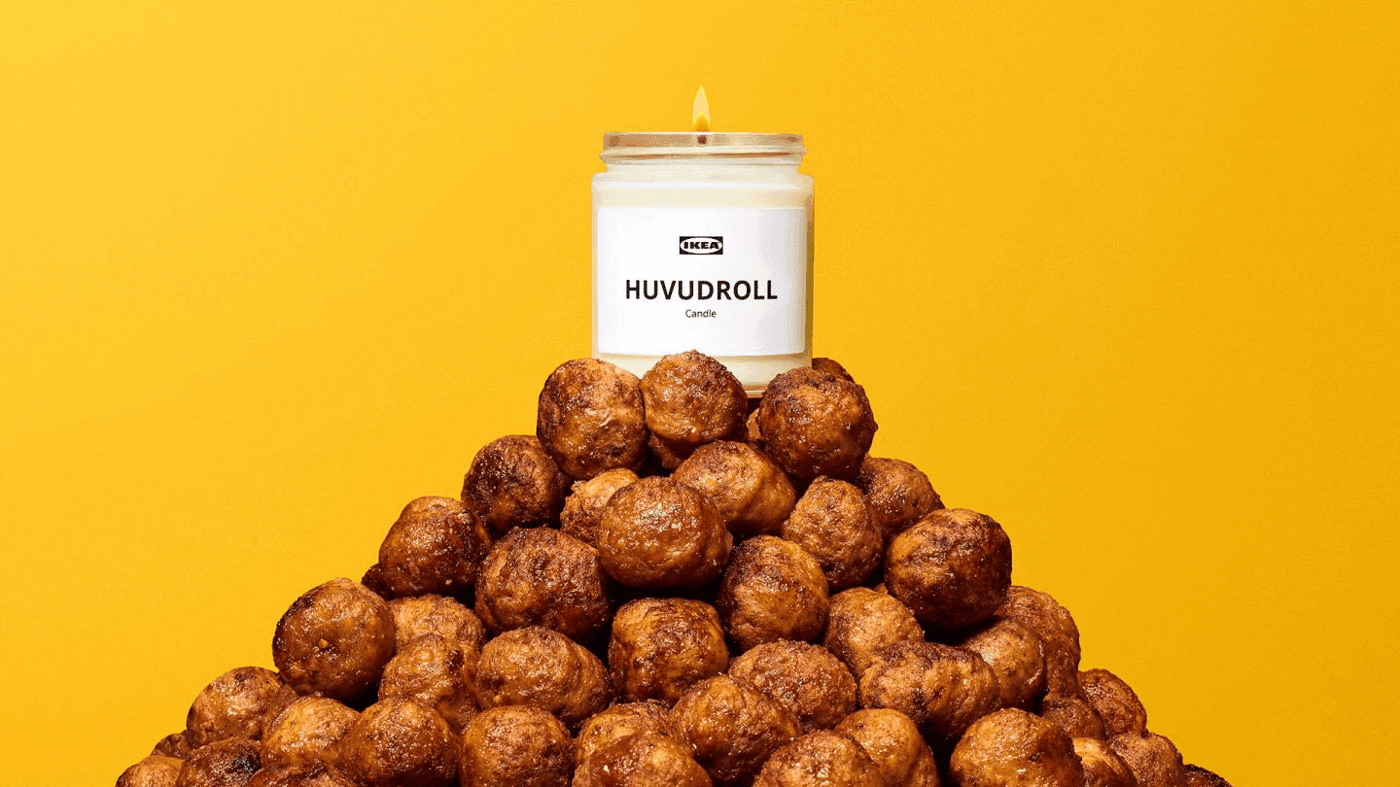 A scented meatball candle sits on top of a pyramid of meatballs.