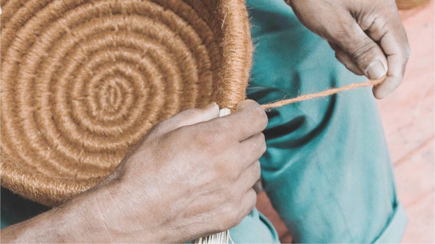 The hands of a worker making an IKEA handmade basket.