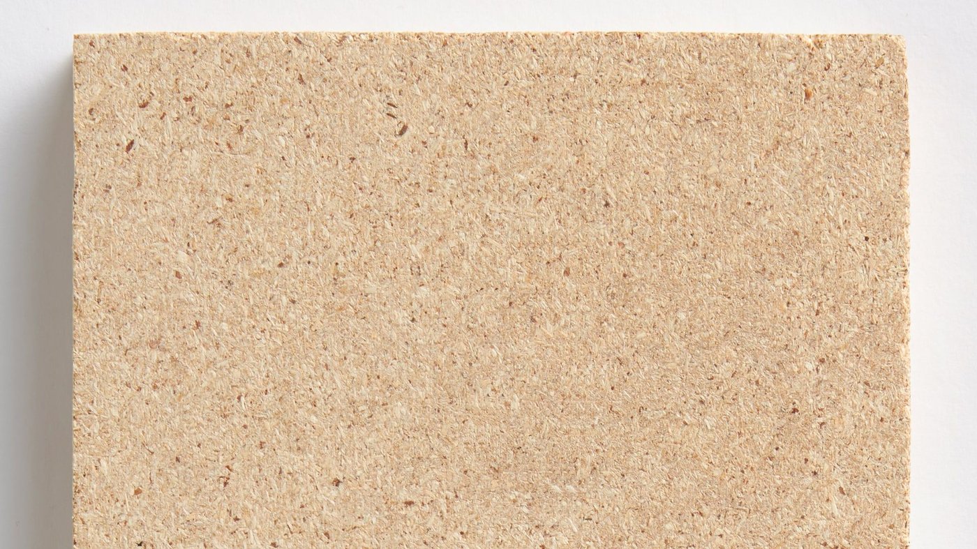 A piece of particle board against a white background.