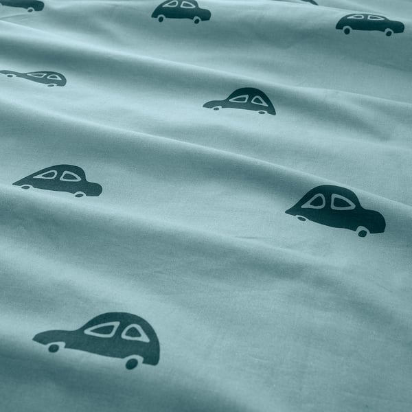 Light blue duvet cover with evenly spaced grey car prints, made of soft, sustainable cotton, showing quality craftsmanship.