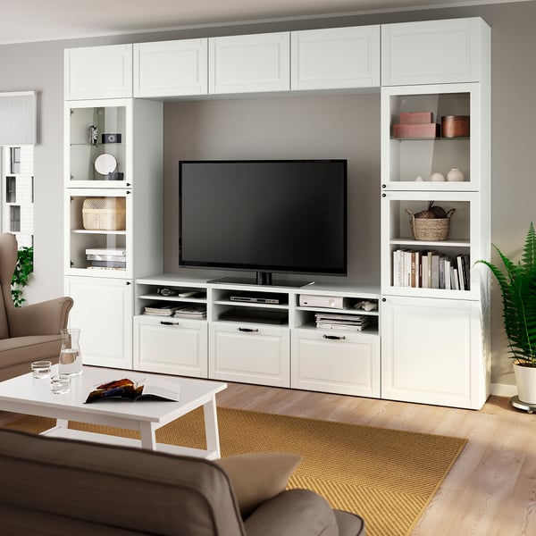 Modern living room with BESTÅ tv unit, plants, and brown sofa.
