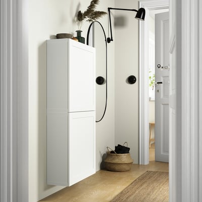 White BESTÅ cabinet, sleek, wall-mounted with storage.