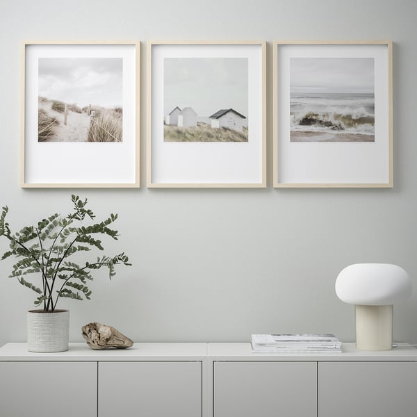 Three coastal photos in frames, decor on shelf