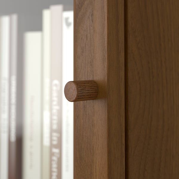 Wooden door handle on BILLY bookcase, smooth and cylindrical.