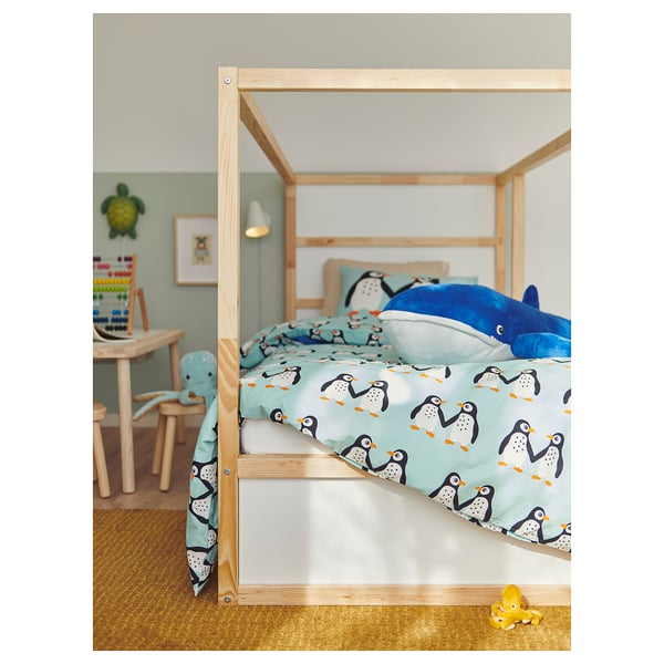 Blue bedroom with penguin bed, whale toy, puzzle, & duck rug