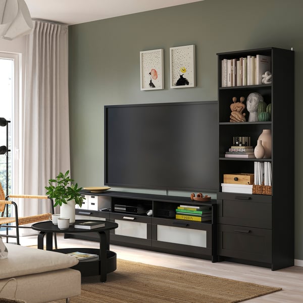 Cosy living room with BRIMNES tv stand & bookcase. Dark grey, modern, holds tv & books neatly. Curated decor; sofa, coffee table, rug; green wall.