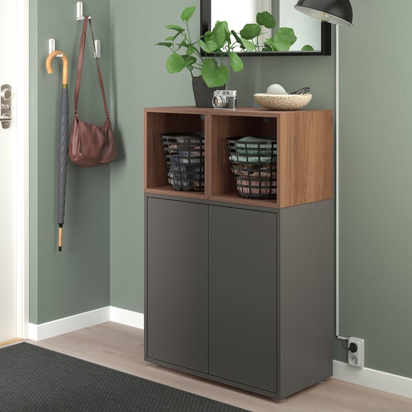 Modern entryway with EKET storage, 2 doors, 2 shelves, wooden top, baskets, umbrella, plant, bowl.