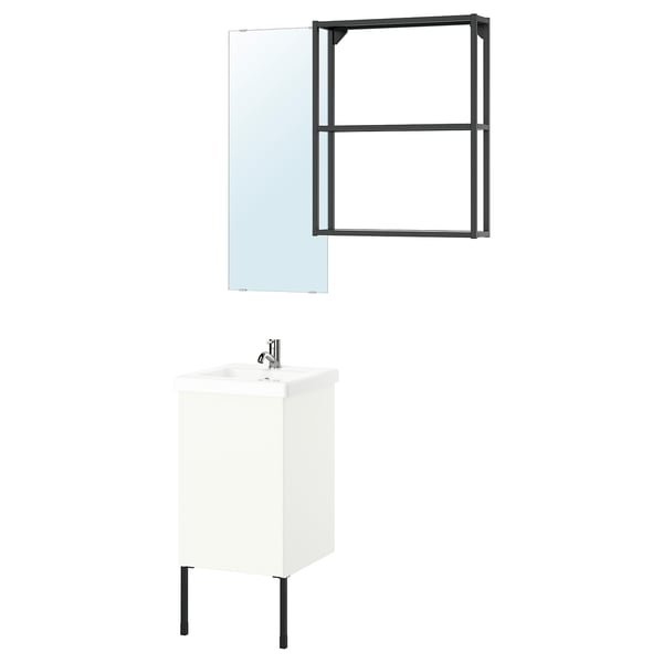 This image an ikea ENHET bathroom setup with a white cabinet and black accents, including a mirror with a metal frame and a sink with a chrome faucet.