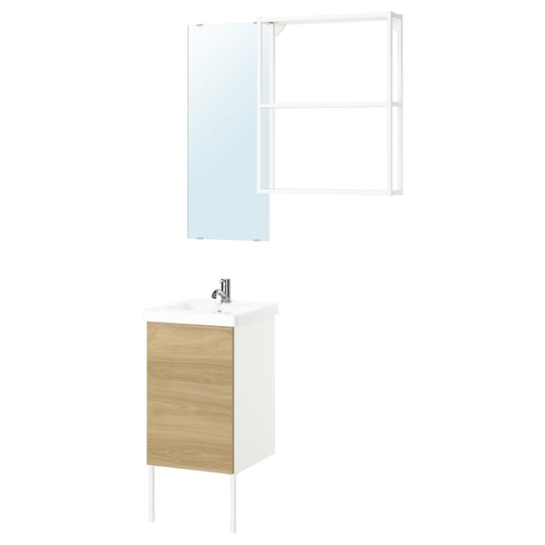 Modern bathroom setup featuring ENHET vanity with light wood cabinet, white counter, and sleek chrome faucet.