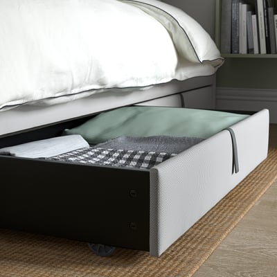 Under-bed storage box with castors and pull handles, designed for easy access to bedding.