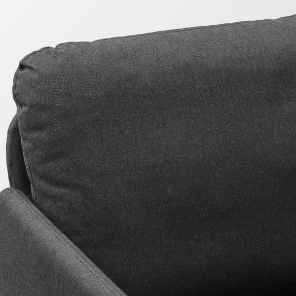 Close-up of GLOSTAD sofas plush, dark grey cushion with neat stitching, showcasing its soft, durable fabric and comfortable design.