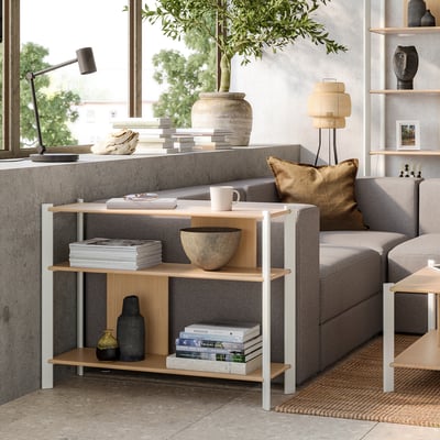 Minimalist living room with JÄTTESTA bamboo shelf, grey sofa, & large window.