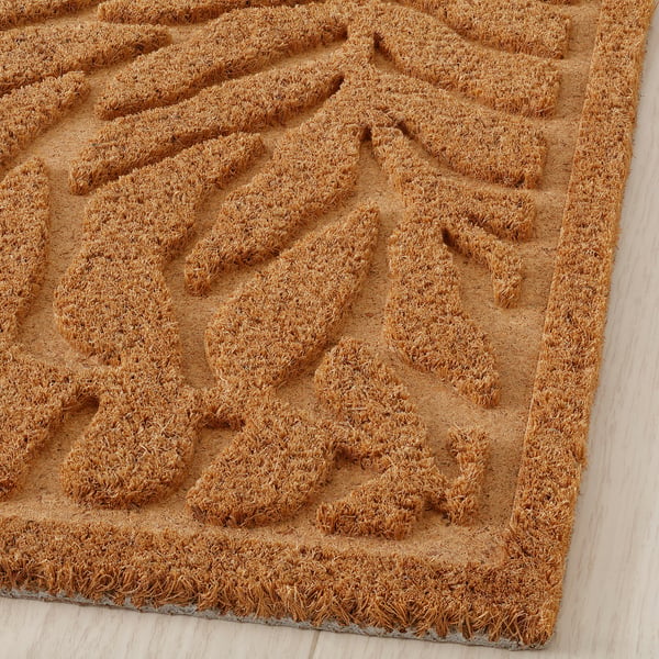 Doormat with raised leaf pattern, coir fibres, 3d textured surface.