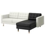 Modern two-tone l-shaped sofa, white & black leather, tufted design, wooden legs.