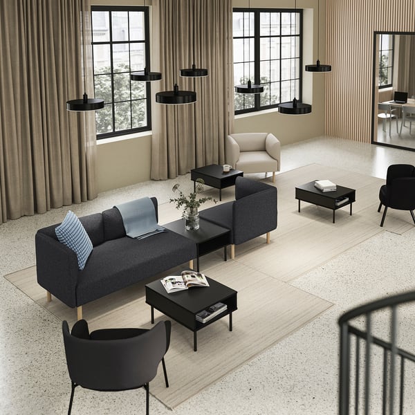 Modern lounge area with grey LILLEHEM sofas, black coffee tables, and black pendant lights.