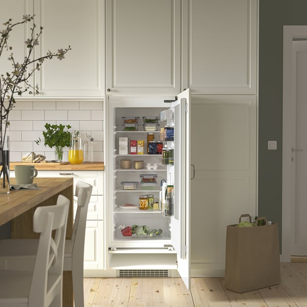 Modern kitchen with integrated fridge; adjustable shelves and transparent door compartments.