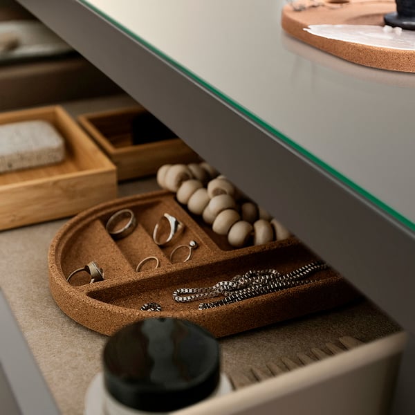 Collection of jewellery neatly arranged in compartments of a stylish, modern box.