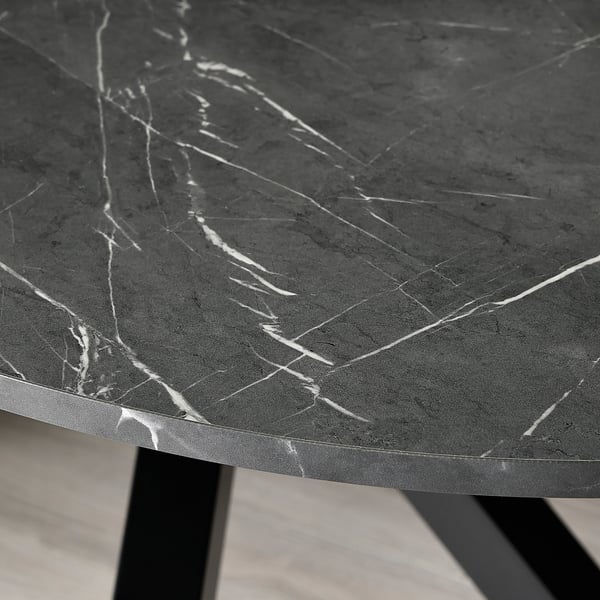 Close-up of sleek, dark MARIEDAMM table with thin white veins, modern and sturdy.
