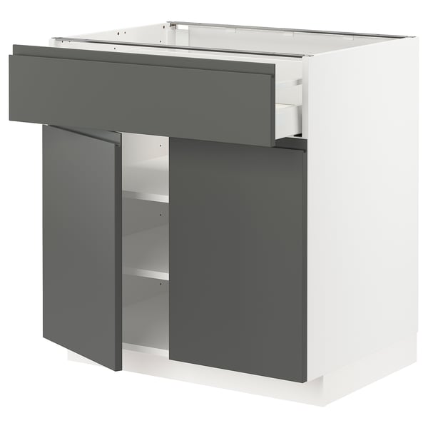 Modern grey kitchen cabinet with drawer and shelves.