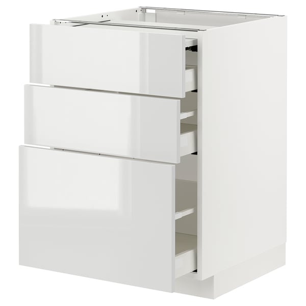 White METOD kitchen unit with glossy drawers, three open, showcasing storage space.