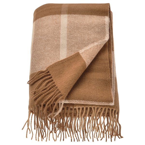 A folded MYRULL throw blanket, light brown with a herringbone pattern and fringe edges, made of 100% wool.