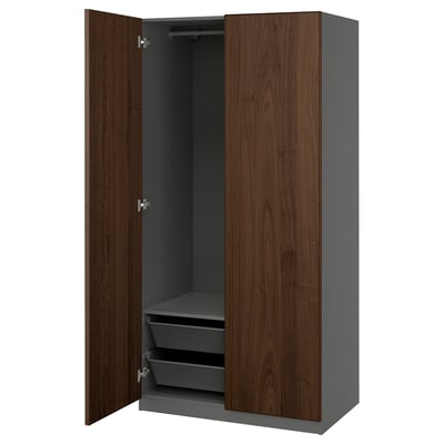 An open brown and gray PAX wardrobe with shelves and mesh baskets, featuring a modern design.