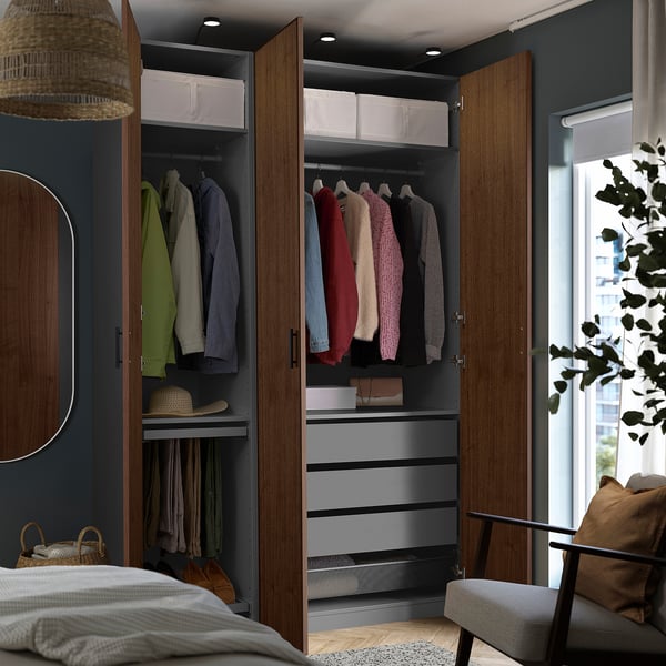 Modern open closet with clothes, organised shelves, drawers, and lighting.