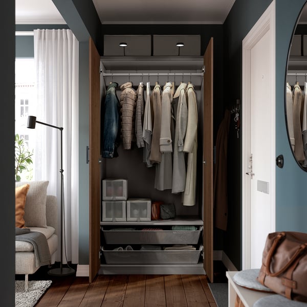 Open wardrobe showcasing coats, drawers, and organisers, highlighting its interior storage solutions.