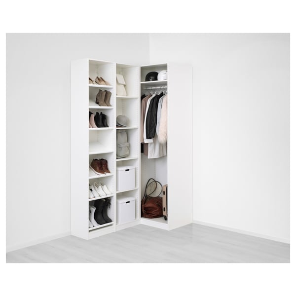 Open closet with shoes, bags, and hanging clothes. White shelves and drawers.