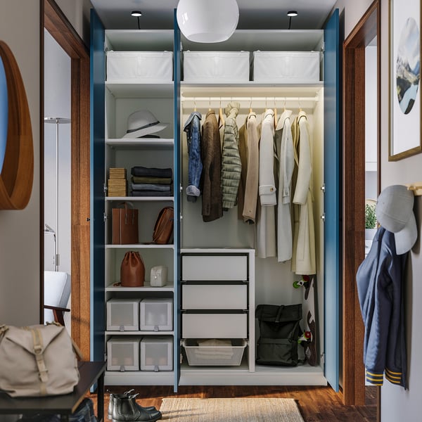 Well-organized closet: clothes hangers, shelves, drawers, and storage bins within a PAX wardrobe.