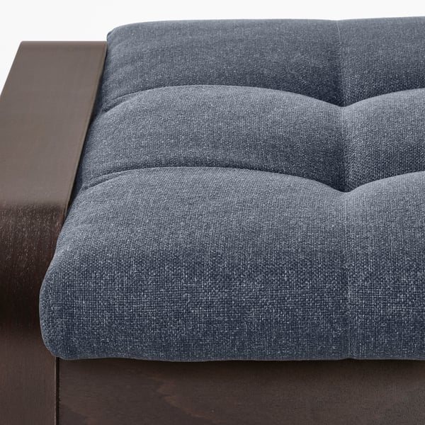 Close-up of a modern, high-quality grey fabric sofa with a dark wooden frame, showcasing its plush, inviting cushions.