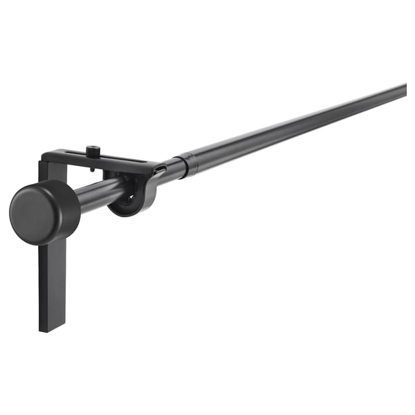 Black RÄCKA curtain rod set with extendable pole, mounts on wall or ceiling, includes 4 brackets and 2 finials.