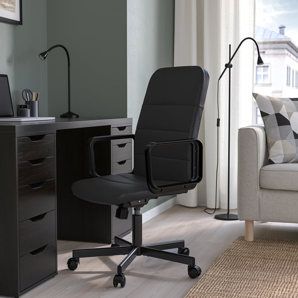 Black RENBERGET office chair in modern home office with desk & sofa.