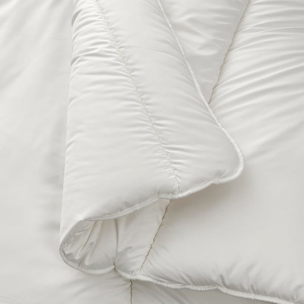 A close-up of a smooth, white duvet with intricate stitching, showcasing its soft, high-quality fabric and craftsmanship.