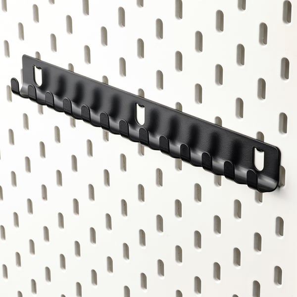 Black SKÅDIS pegboard with hooks, horizontal, tool-free access for small items.